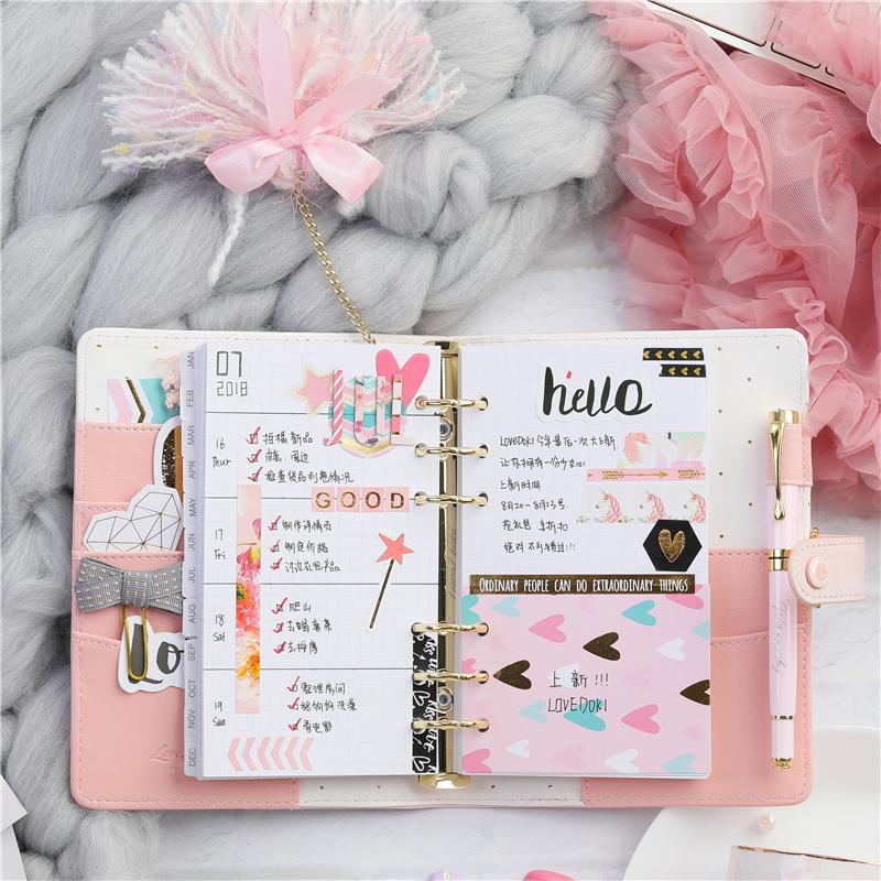 Blank paper notebook, pink flowers, golden stationery on marble